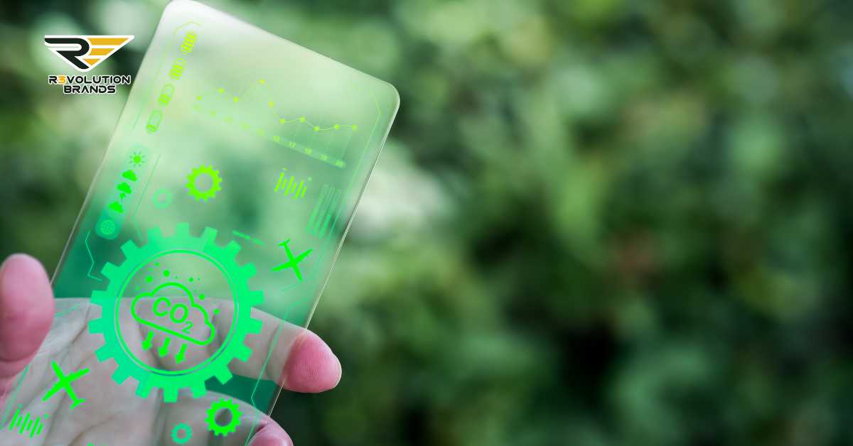 The image shows a hand holding a transparent, futuristic card that features digital green graphics overlay, displaying various icons and symbols like gears, CO2, and other environmental elements. These symbols suggest a theme related to sustainability or environmental monitoring. The card prominently displays the logo of R3volution Brands, suggesting its association with the company. The background is blurred with green foliage, enhancing the theme of nature and sustainability.