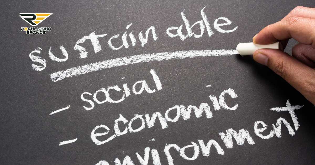 The image displays a hand writing the word "Sustainable" with chalk on a blackboard, with the words "social," "economic," and "environment" listed underneath as elements of sustainability. The R3volution Brands logo is placed at the top left, indicating the brand's commitment to sustainability and social responsibility in its business practices. The overall theme of the image emphasizes the importance of considering social, economic, and environmental factors in developing sustainable business models.